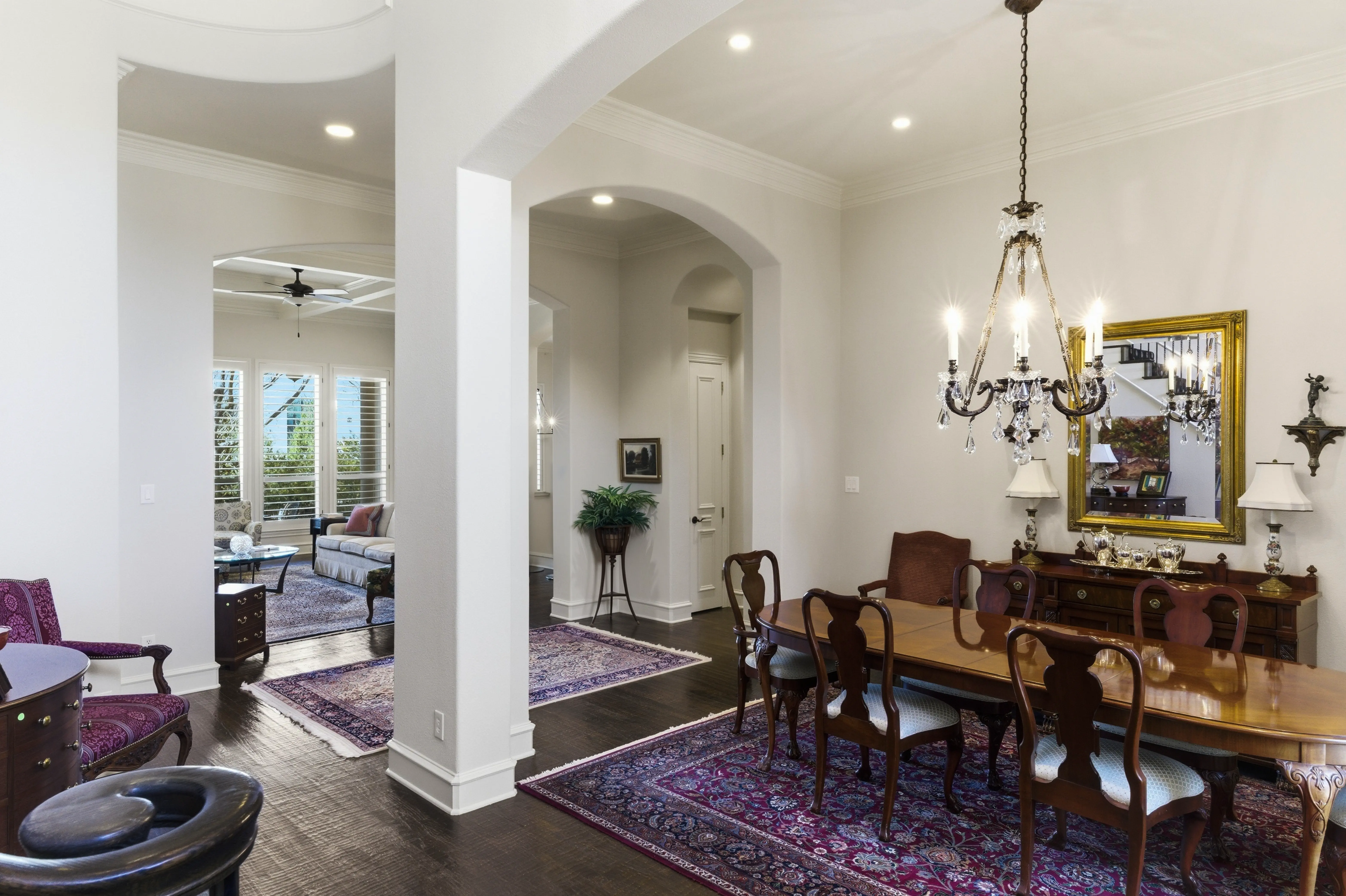 Elegant foyer with arched openings and iron railing staircase